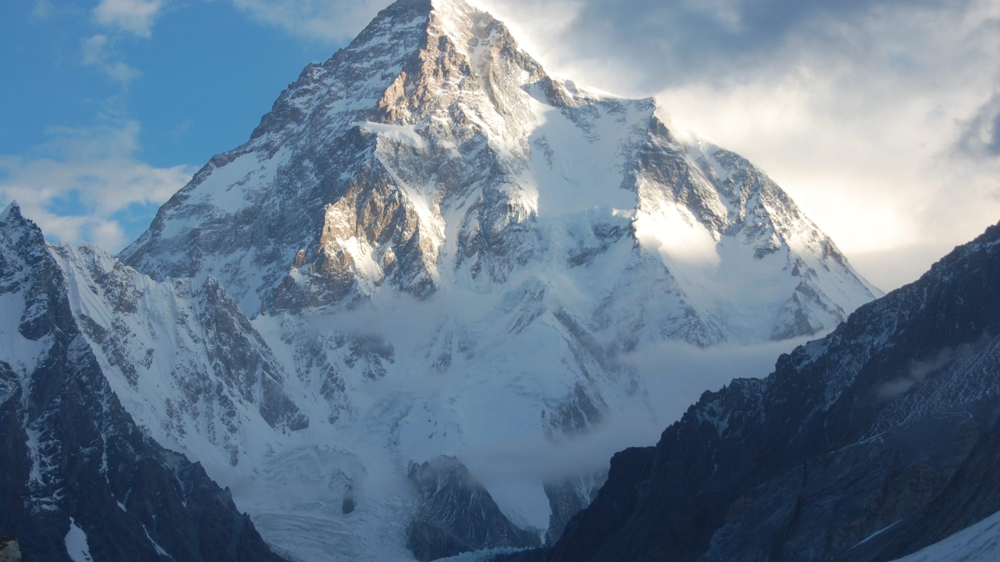 K2's massive pyramidal summit lit by evening sun above the Karakoram Range, Gilgit-Baltistan, Pakistan