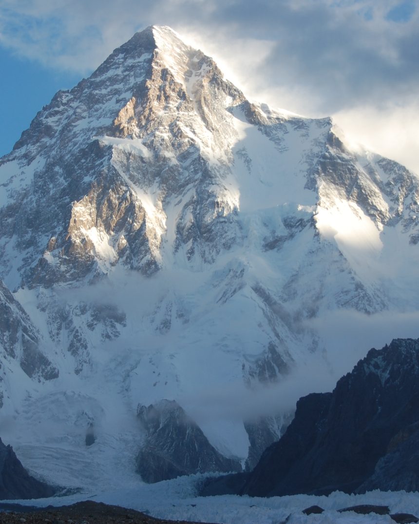 K2's massive pyramidal summit lit by evening sun above the Karakoram Range, Gilgit-Baltistan, Pakistan