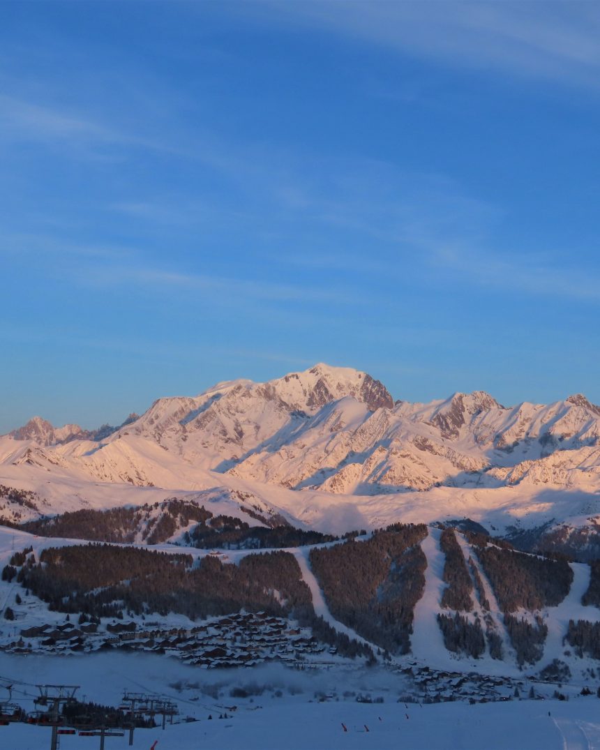 The snow-covered Mont Blanc massif glowing at golden hour above the Savoie valley, viewed from Signal de Bisanne, France