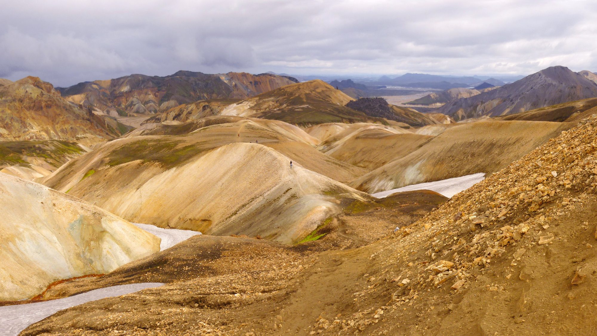 Panoramic view of the multicoloured rhyolite mountains of Landmannalaugar with distant hikers on the Laugavegur trail, Iceland