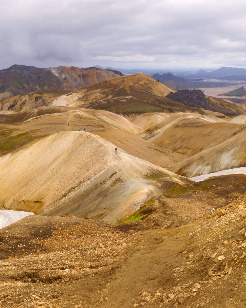 Panoramic view of the multicoloured rhyolite mountains of Landmannalaugar with distant hikers on the Laugavegur trail, Iceland